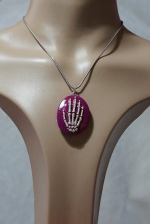 Pink and white skeleton hand cameo necklace